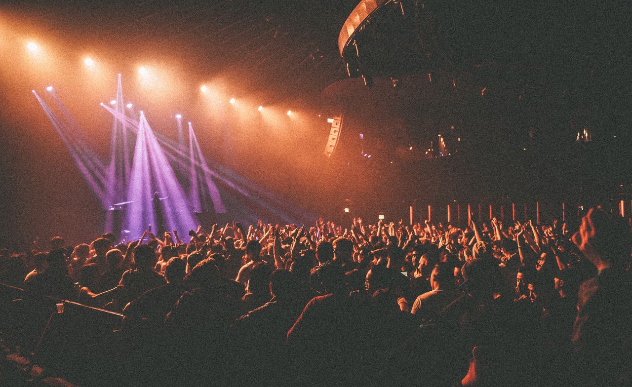 Crowd at a live concert under purple lights